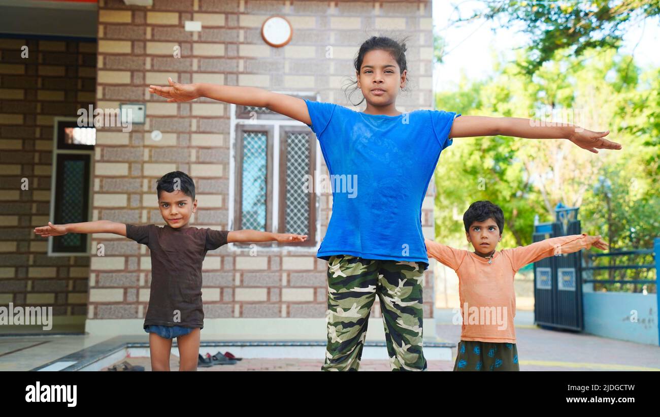 Asian Girl doing gymnastic exercises or exercising in fitness class with little siblings. Stock Photo
