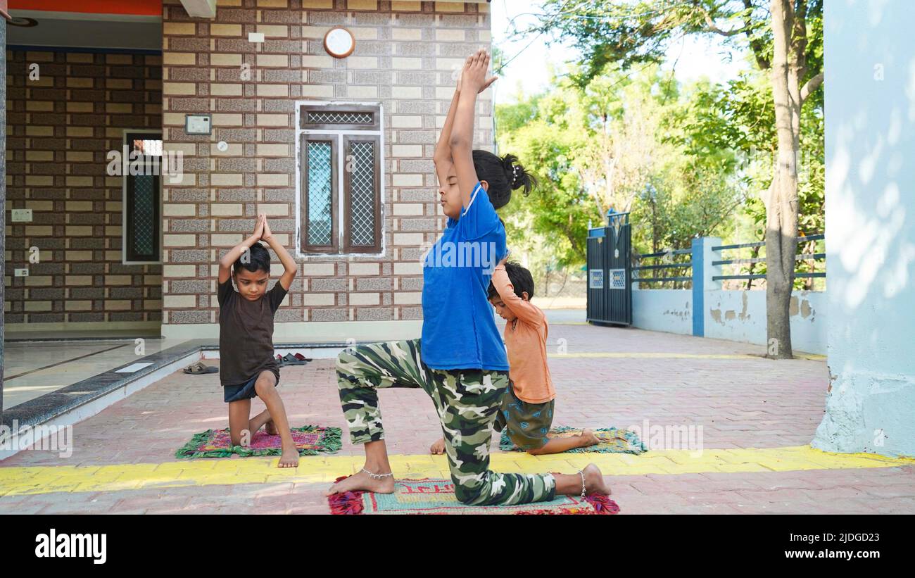 Asian Girl doing gymnastic exercises or exercising in fitness class with little siblings. Sport concept. Healthy lifestyle. Active hobbies Stock Photo