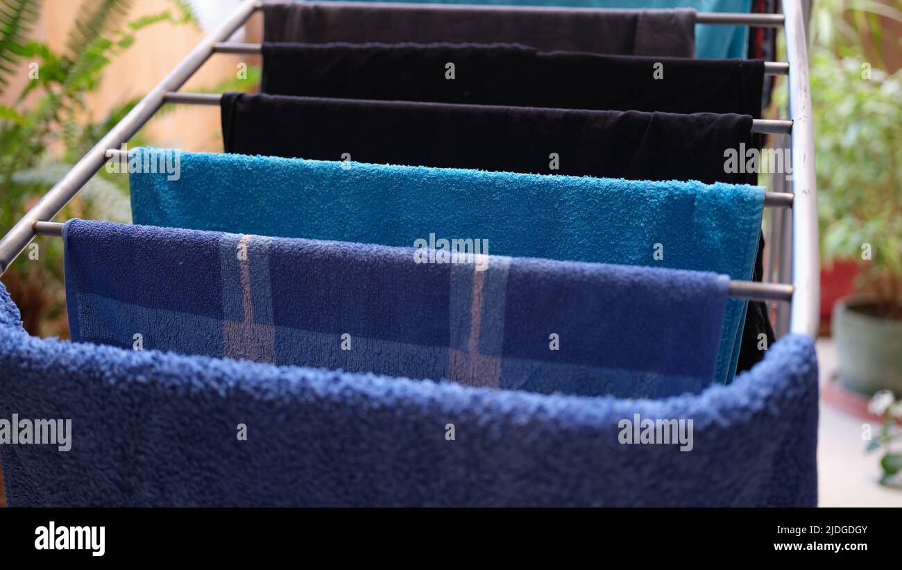 Metal clothes dryer with towels and clothing Stock Photo Alamy