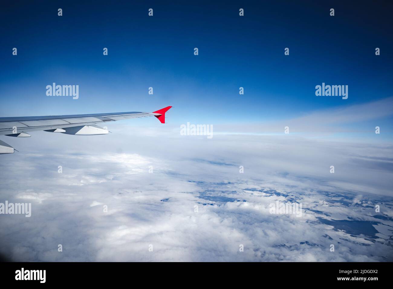 Aircraft wing above beautiful clouds and blue sky Stock Photo - Alamy