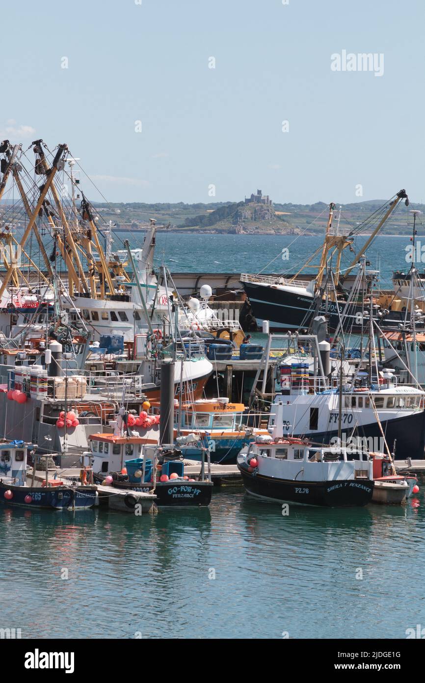 A busy Newlyn Fishing Harbour with a jumbled assortment of different boats and ships Stock Photo