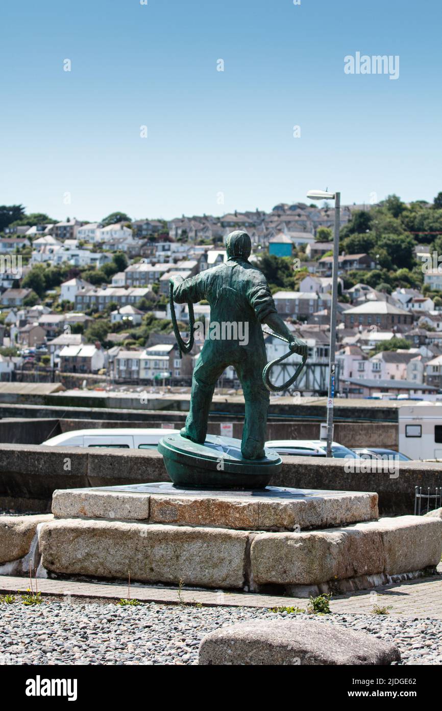 Lost at Sea monument with Statue of fisherman casting a rope, situated on seafront at Newlyn Cornwall Stock Photo