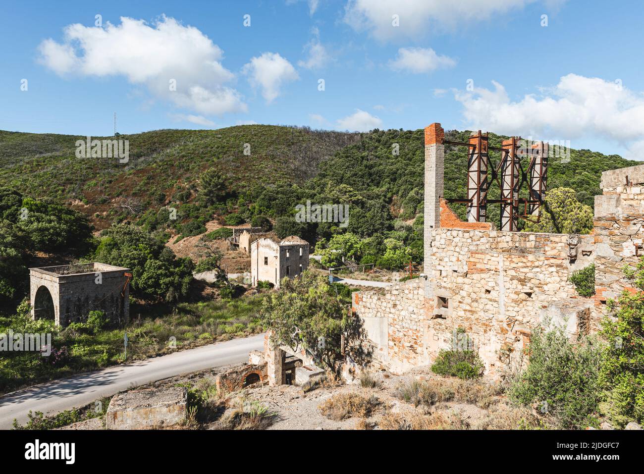Deteriorated facades and rusty metal parts in the ruins of the abandoned Naracauli ore mine near Ingurtosu, Costa Verde, Sardinia, Italy Stock Photo