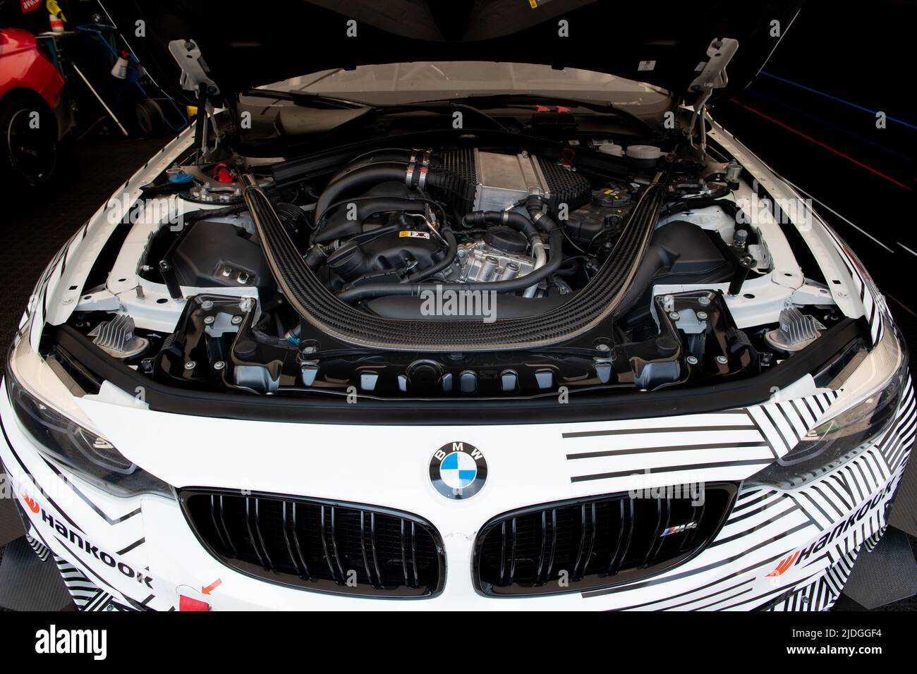 BMW M4 GT racing super car in box circuit, open hood.and visible engine Imola, Italy, june 17 2022. DTM Stock Photo