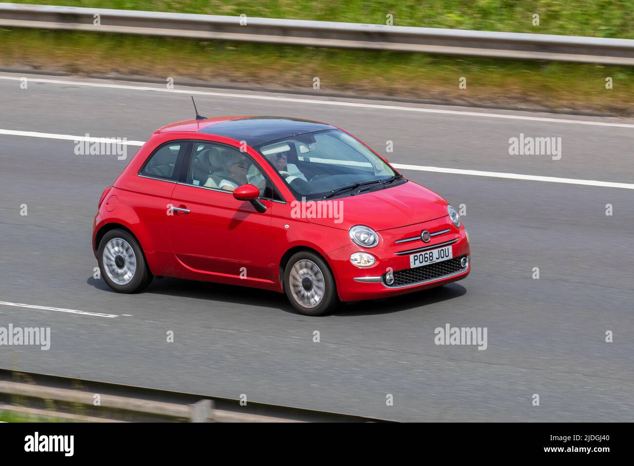 2018 red Fiat 500 1242cc petrol small city car driving on the M6 Motorway, Manchester, UK Stock Photo