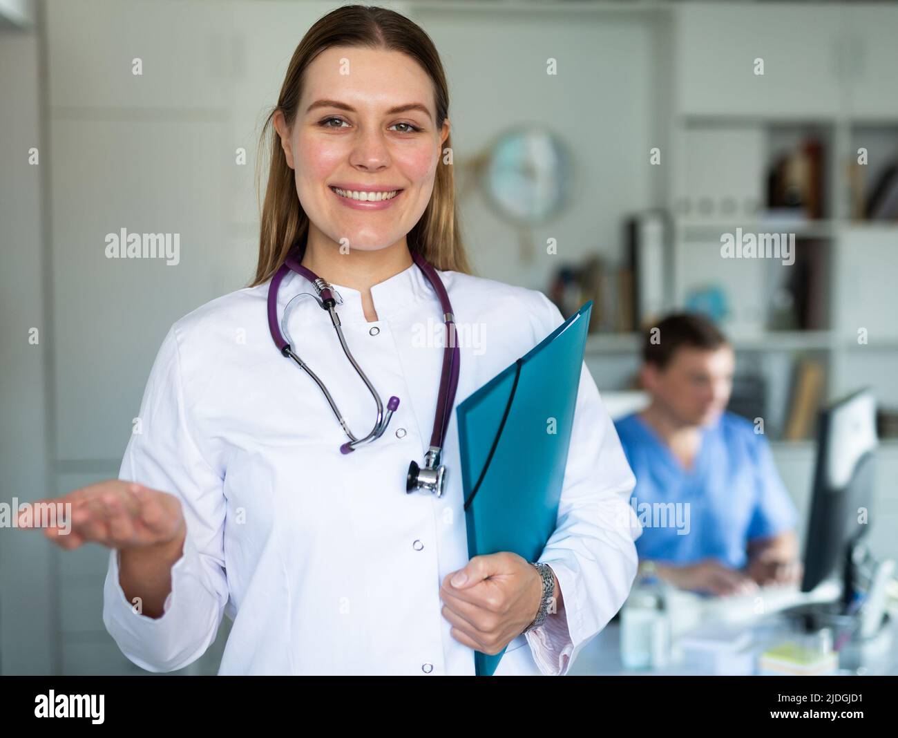 Female doctor inviting in hi-res stock photography and images - Alamy
