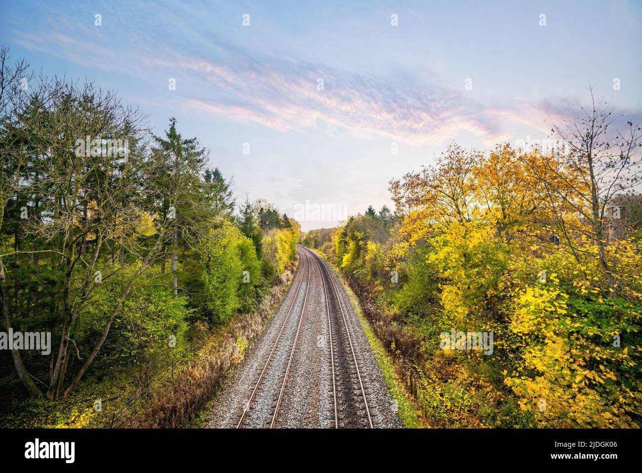Colorful autumn scenery with a railroad track going through the landscape Stock Photo