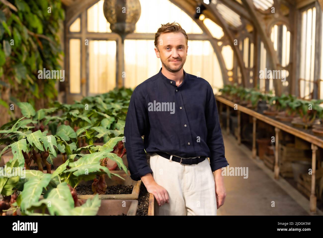 EDITORIAL USE ONLY Tom Felton unveils the new 'Professor Sprout's Greenhouse' set at Warner Bros