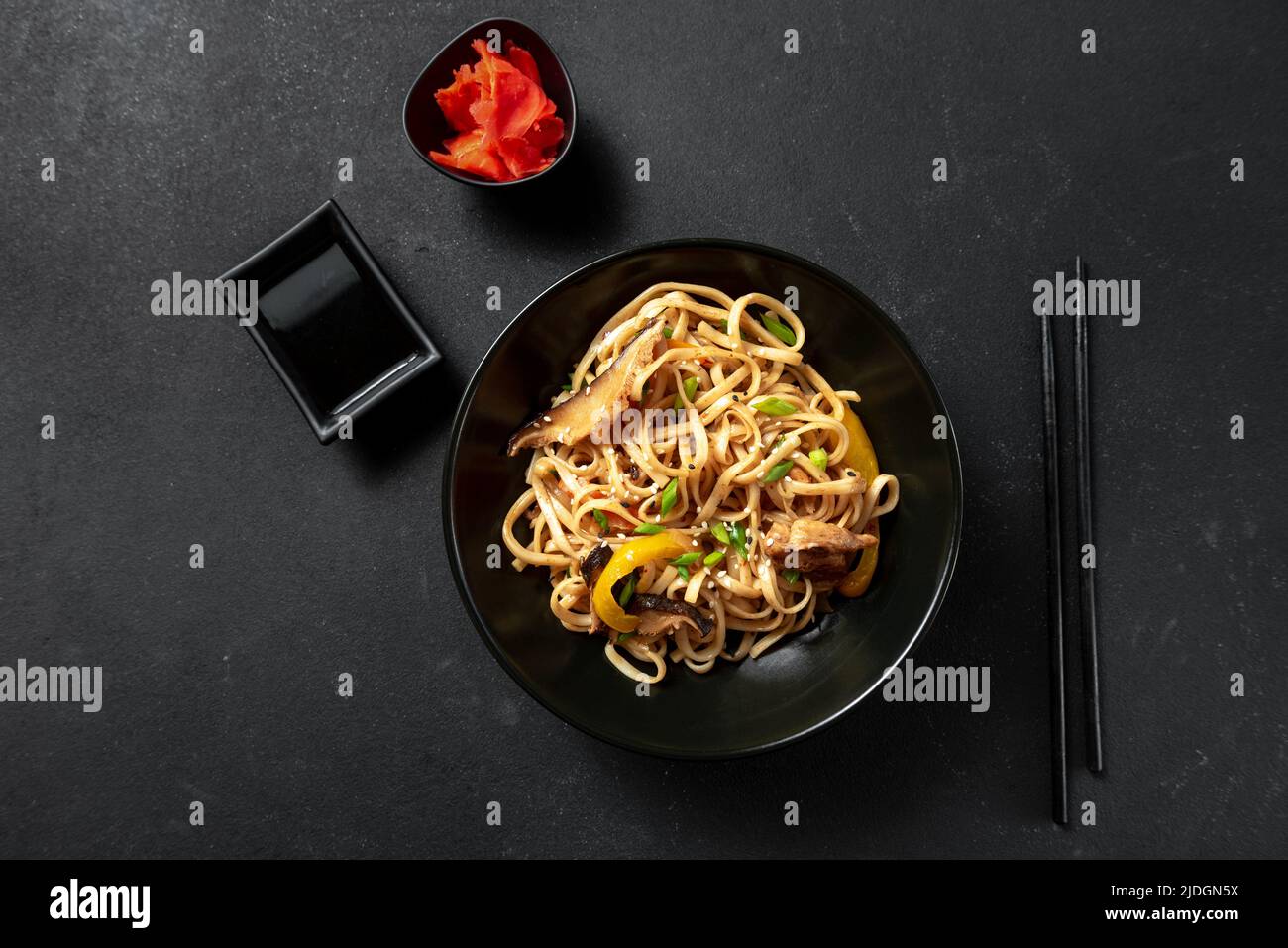 Vegetarian Schezwan Noodles or Vegetable Hakka Noodles or Chow Mein in black bowl at dark background. Schezwan Noodles is indo-chinese cuisine hot dis Stock Photo