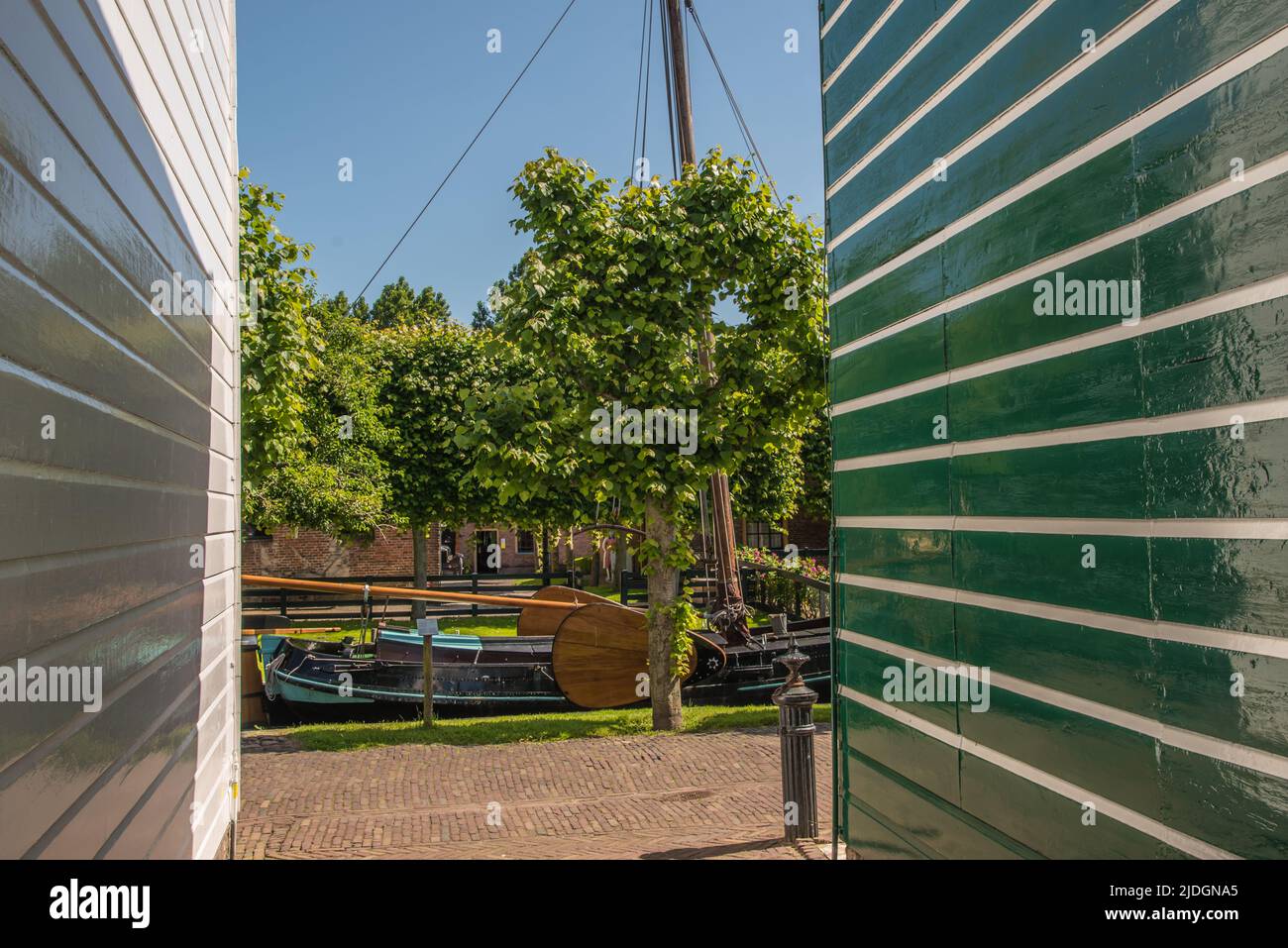 Enkhuizen, Netherlands, June 2022. View through the wooden facades on a historic sailboat in Enkhuizen. High quality photo Stock Photo