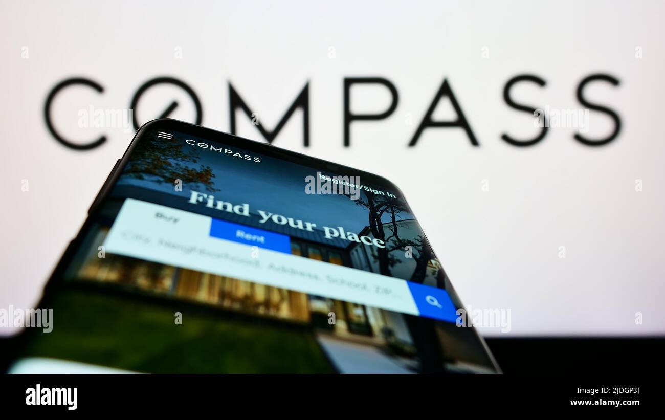 Mobile phone with webpage of American real estate company Compass Inc