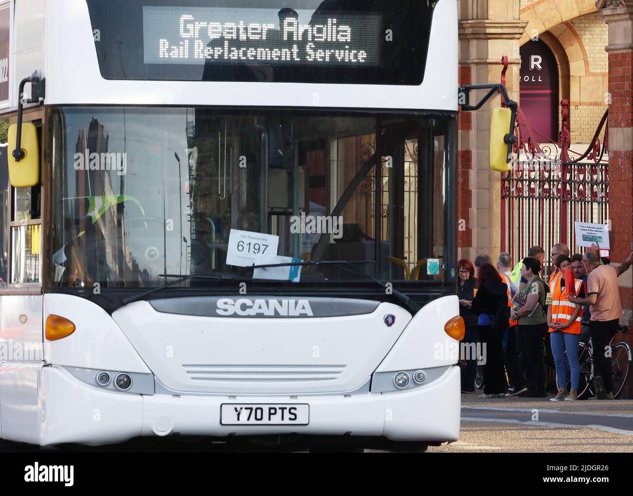 Leicester, Leicestershire, UK. 21st June 2022. Rail workers stand on a picket line behind a rail replacement bus as they stage the first of three national strikes. The RMT called the strikes over job cuts, pay and conditions. Credit Darren Staples/Alamy Live News. Stock Photo