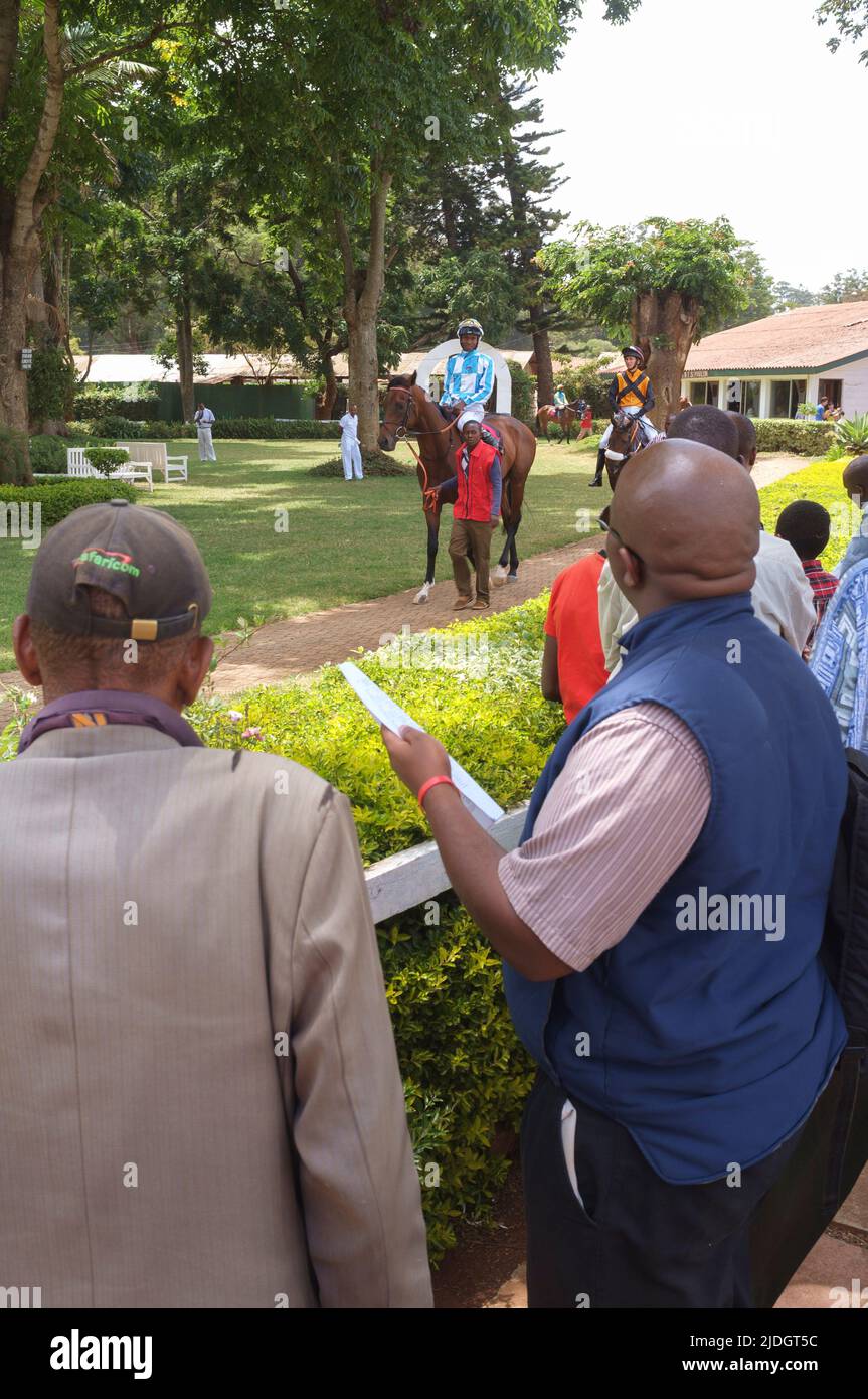 Spectators watching horses being led round the parade ring before a race, Ngong Racecourse, Ngong Road, Nairobi, Kenya.  1 Mar 2015 Stock Photo