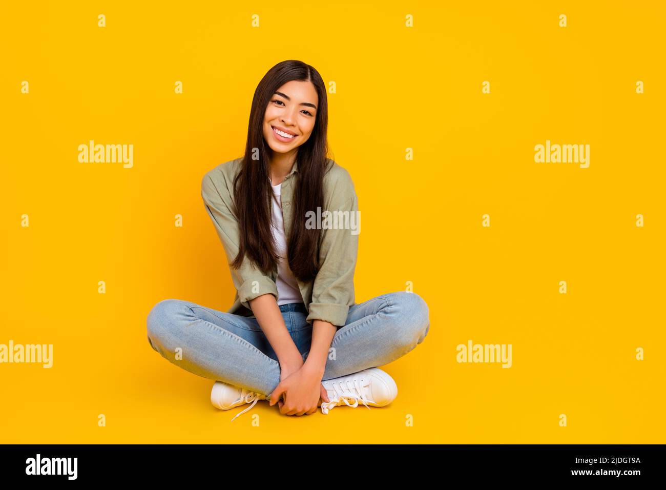 Full size portrait of adorable satisfied young person sitting floor ...