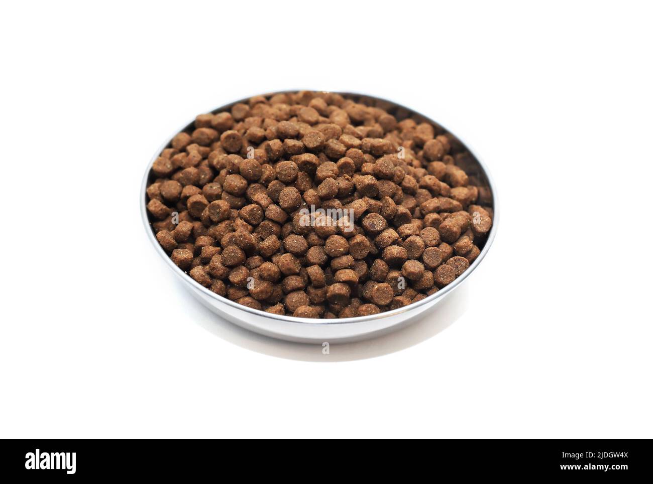 Metal bowl with dry food for domestic animals. Isolated with clipping path Stock Photo