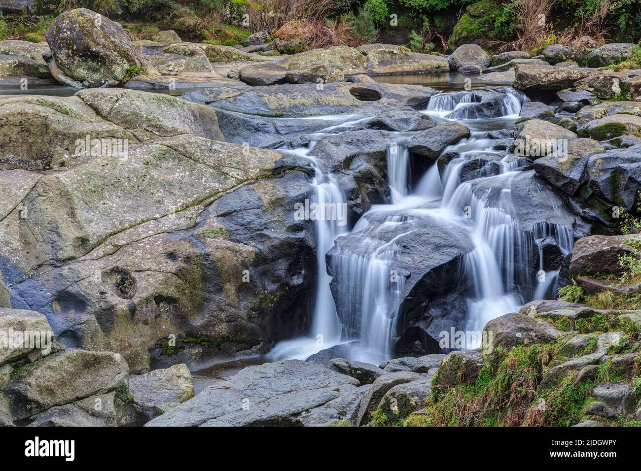 A waterfall cascading gracefully through a landscape of rock ledges. McLaren Falls Park, New Zealand Stock Photo
