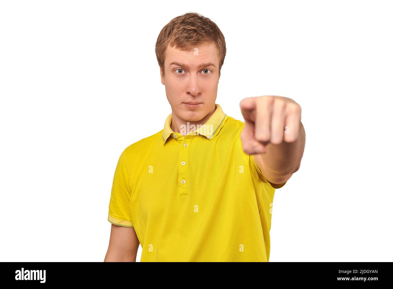 Handsome guy in casual yellow Polo Tshirt pointing finger forward