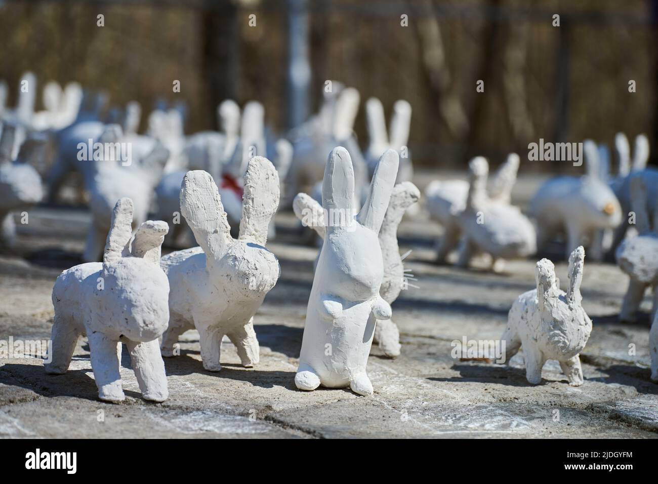 White rabbit statues made of plaster at outdoor art exhibition ...