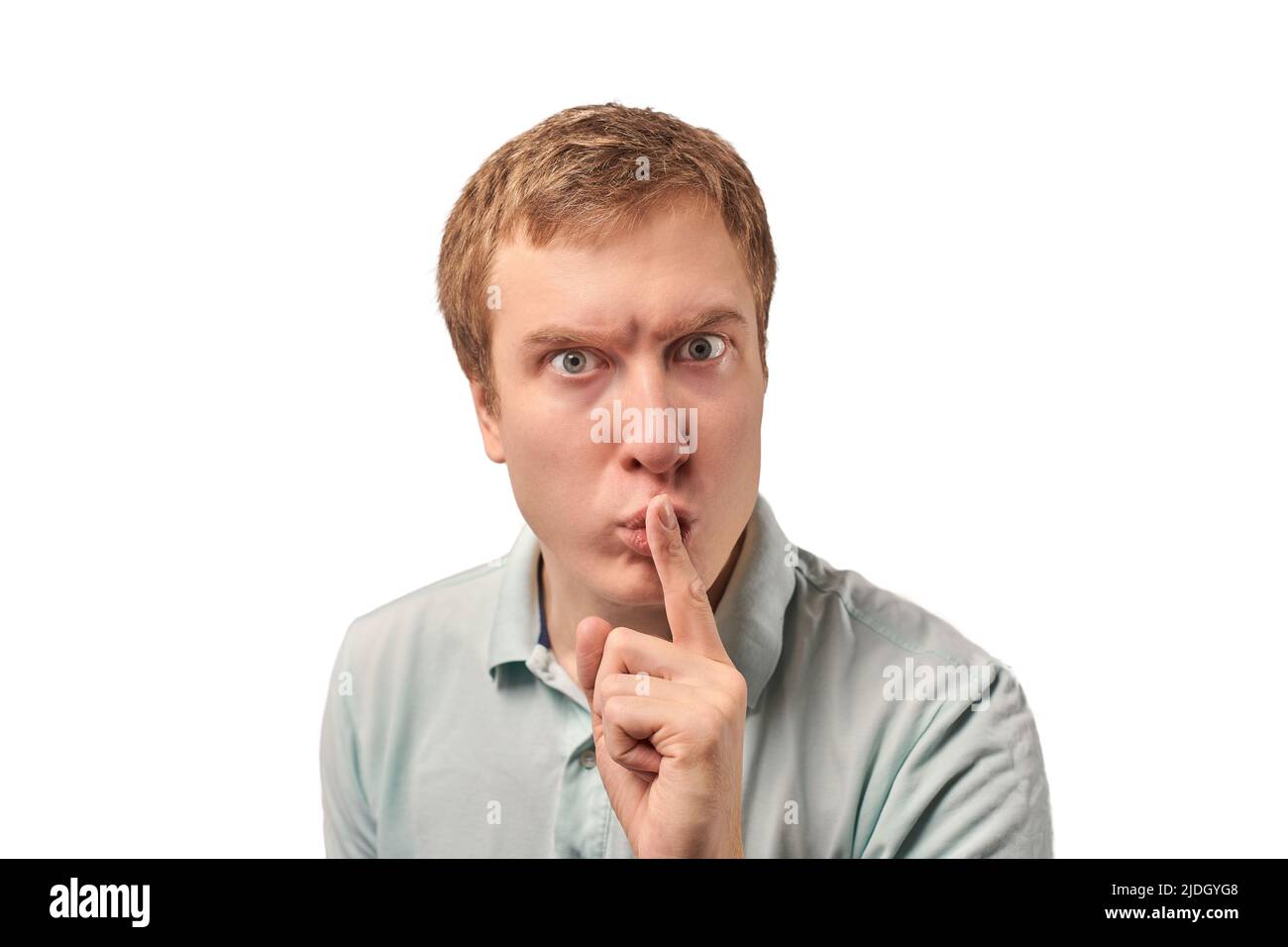 Funny guy in light gray Polo Tshirt asking to be quiet, silence
