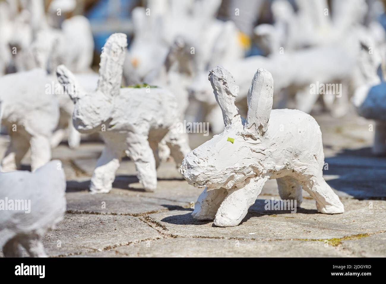 White rabbit statues made of plaster at outdoor art exhibition, artificial  white hares on city street. A lot of white handmade rabbits, many decorativ  Stock Photo - Alamy