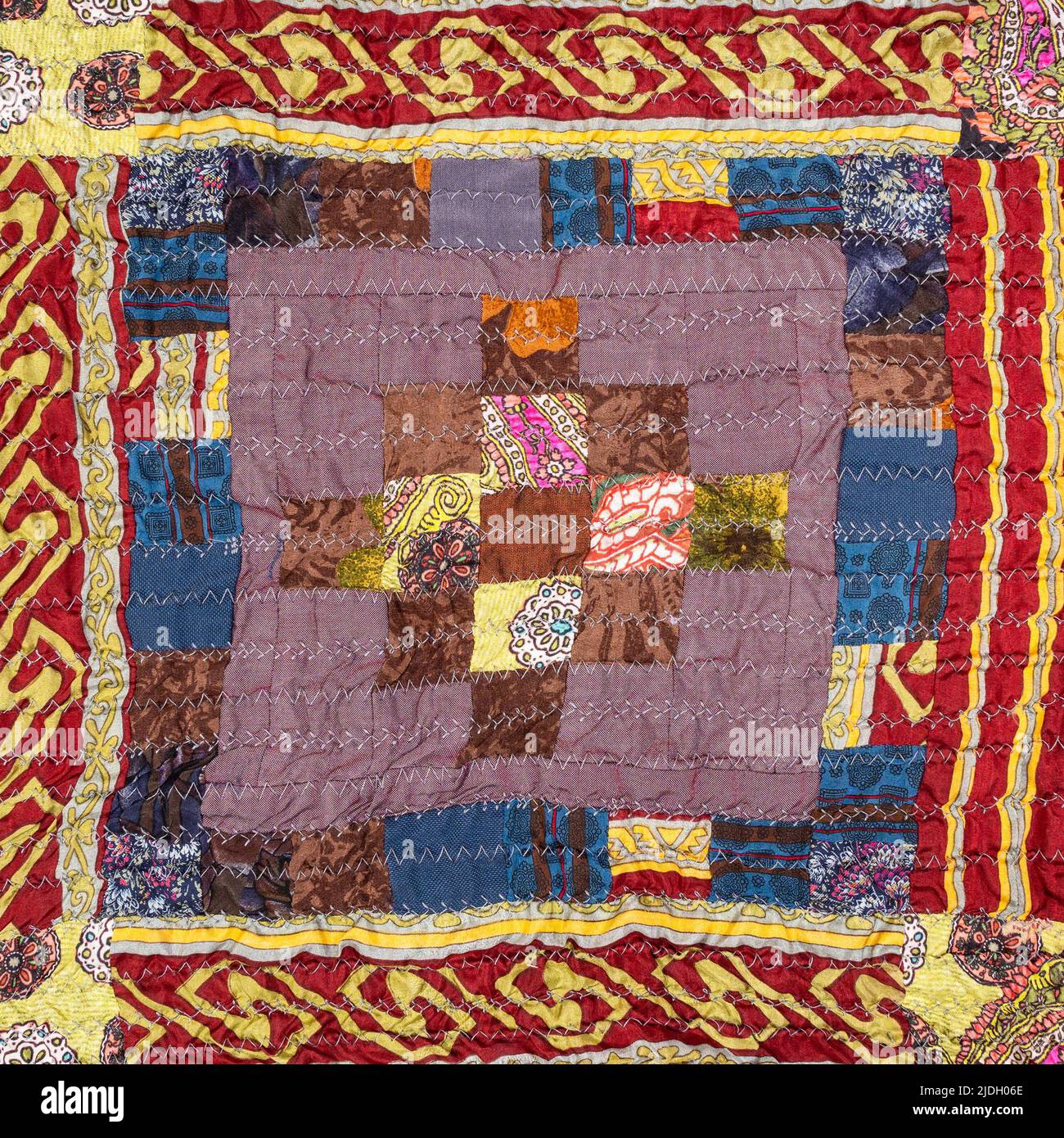 pattern on handcrafted crinkled silk patchwork scarf with geometric pattern close up Stock Photo