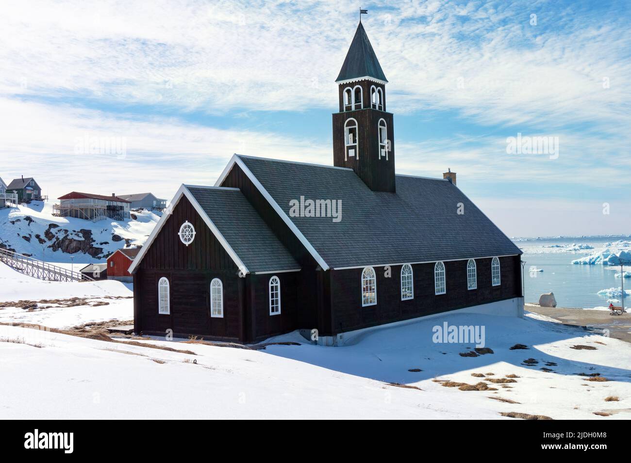 Zion church in Ilulissat Greenland with sunny snowy landscape Stock Photo