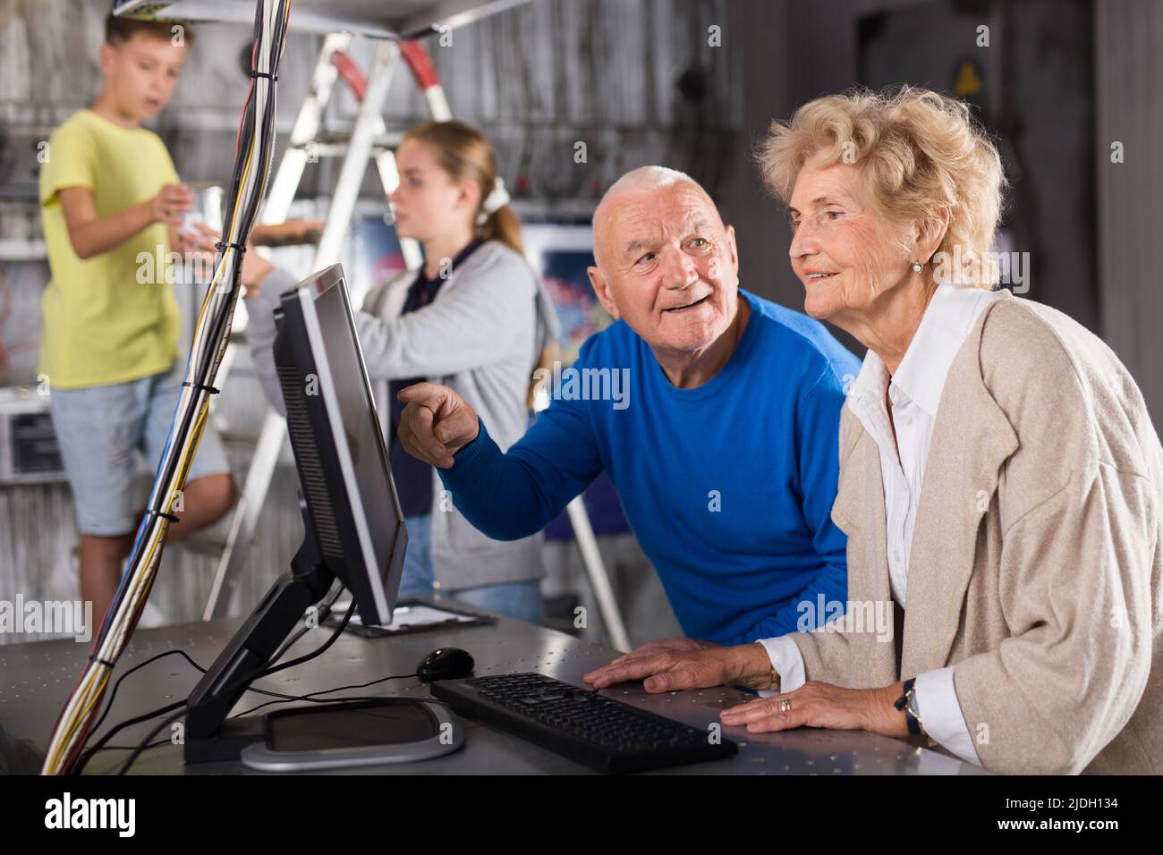 Family is using PC in time having fun together in lost labroom Stock ...