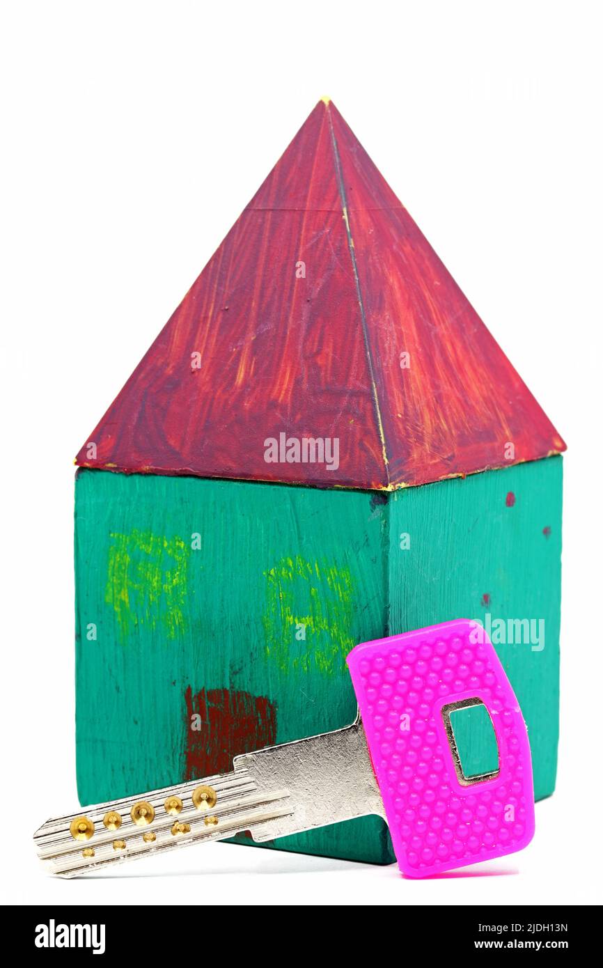 Key to the small house isolated on white background Stock Photo - Alamy