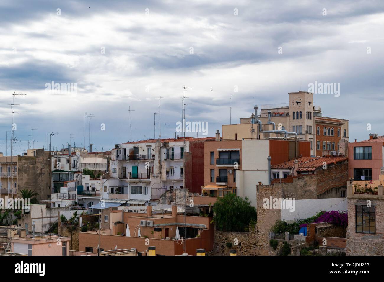 Cloudy skies over the houses at Tarragona port neighborhood Stock Photo