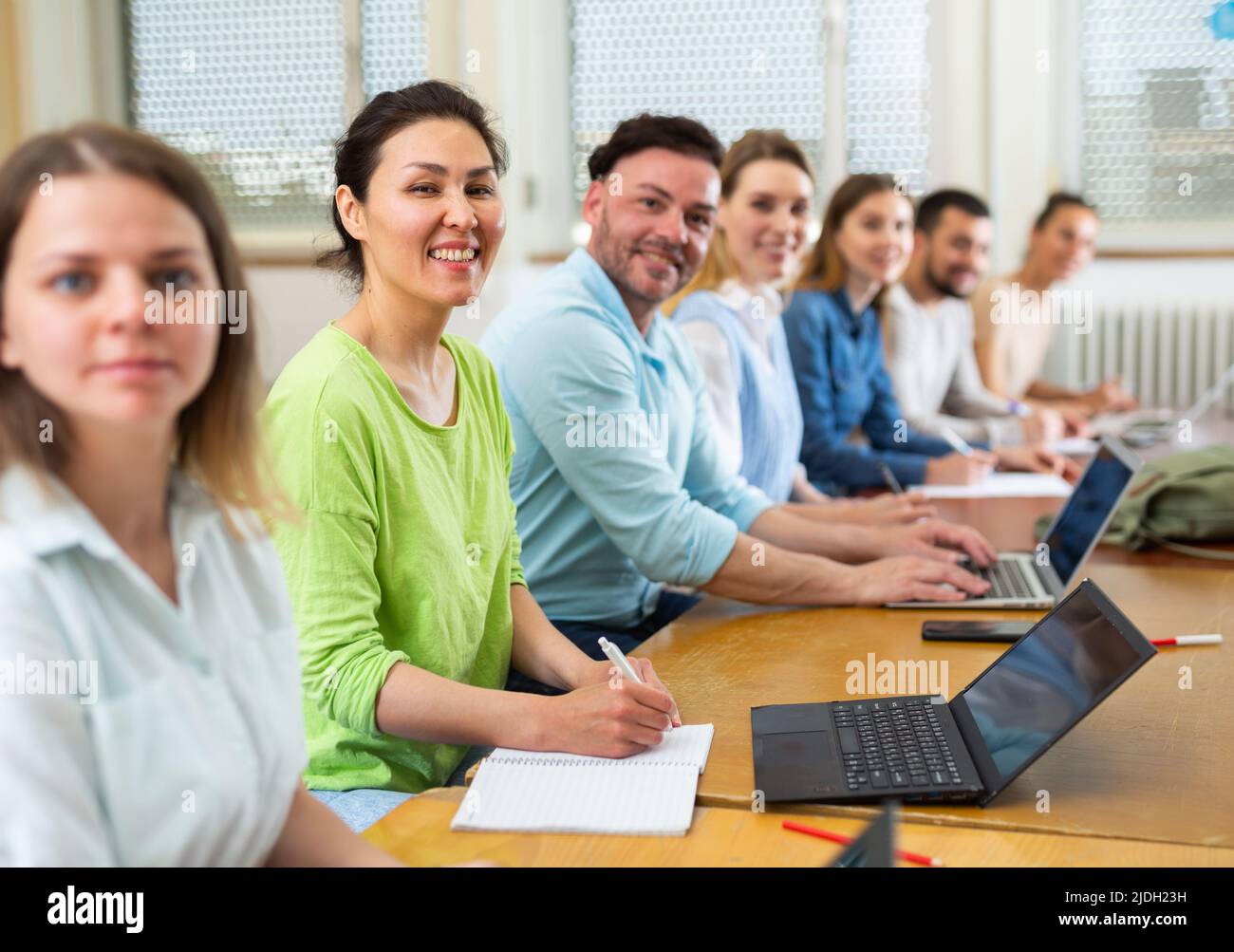 Group students listening and writing during business course Stock Photo