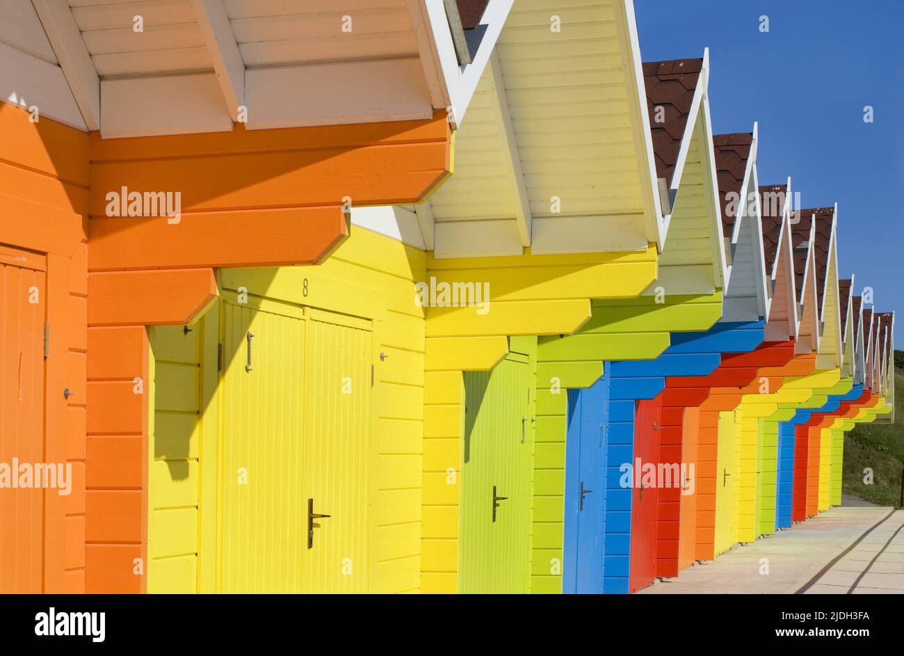 brightly coloured beach huts, United Kingdom, England, North Yorkshire, Scarborough Stock Photo
