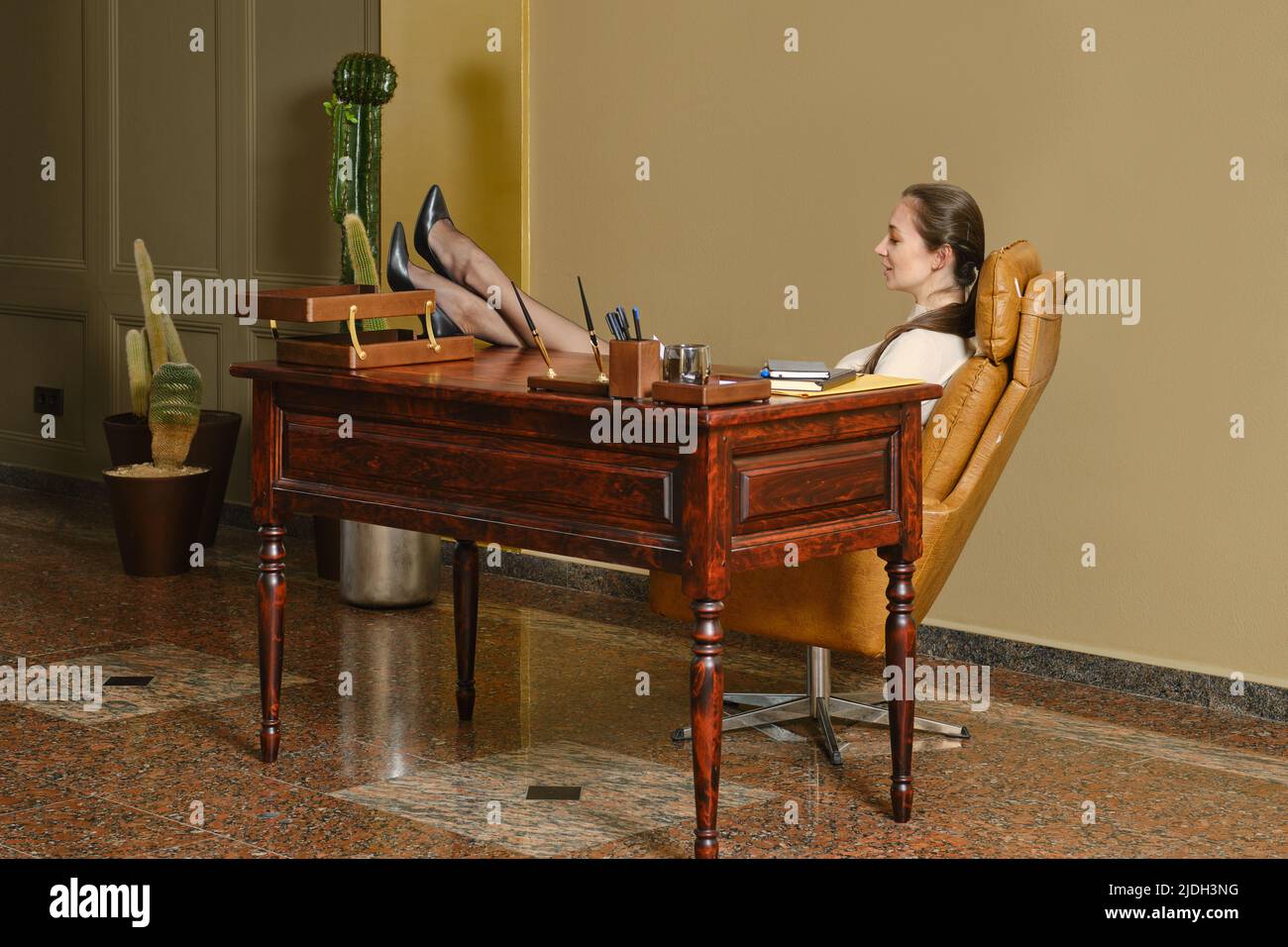 Businesswoman sitting desk legs up hi-res stock photography and images ...
