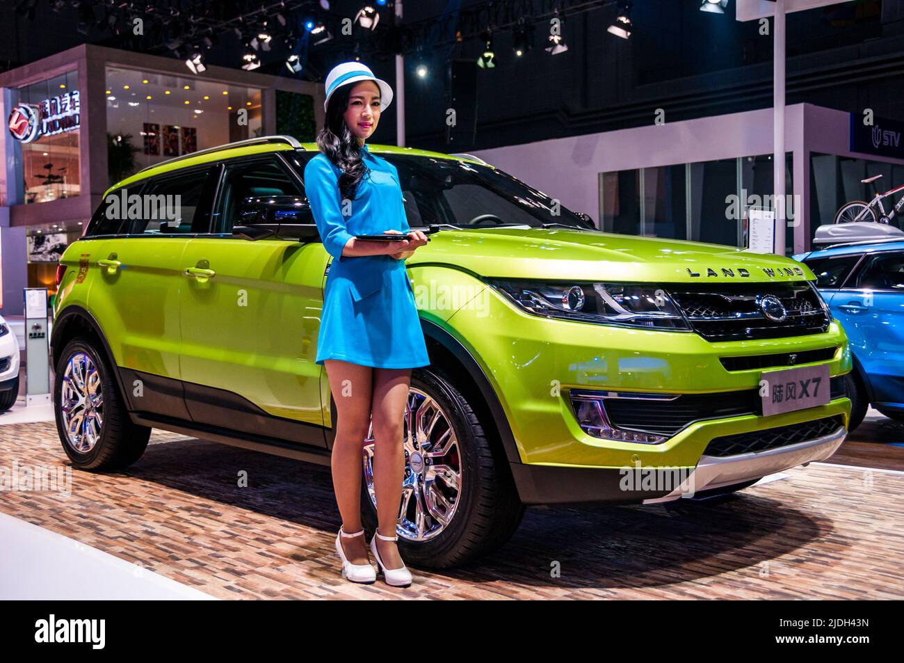 A model stands in front of the Landwind X7, a Range Rover Evoque clone, at the 2015 Shanghai Auto Show. Stock Photo