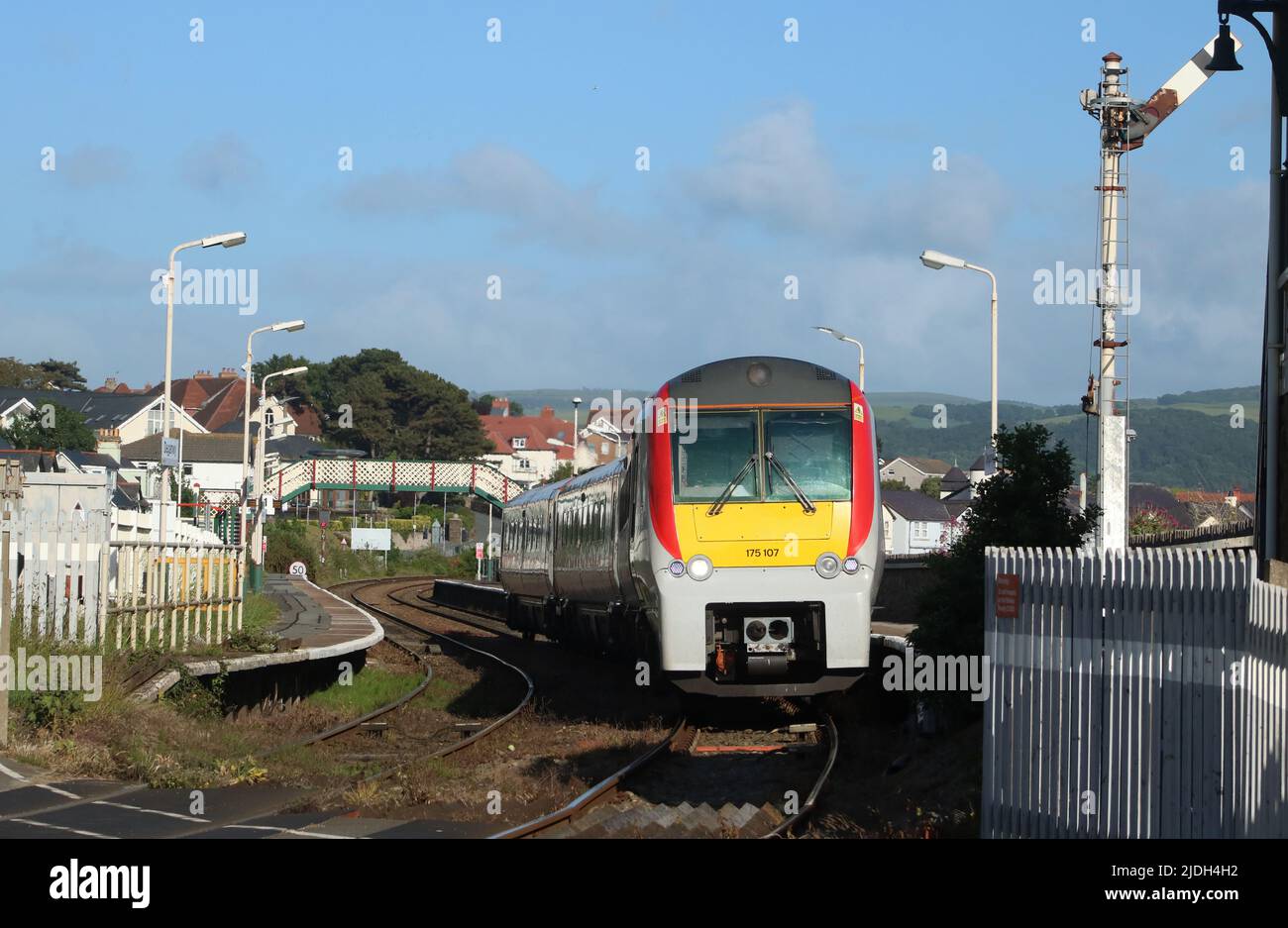 Transport for Wales class 175 Coradia 1000 dmu, unit number 175107, leaving Deganwy station and about to cross the level crossing at end of station. Stock Photo