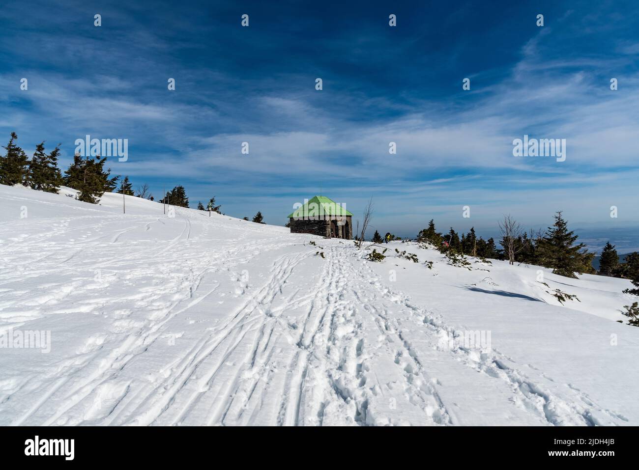 stone hut on Jeleni studanka in Jeseniky mountains in Czech republic during beautiful winter day with blue sky Stock Photo