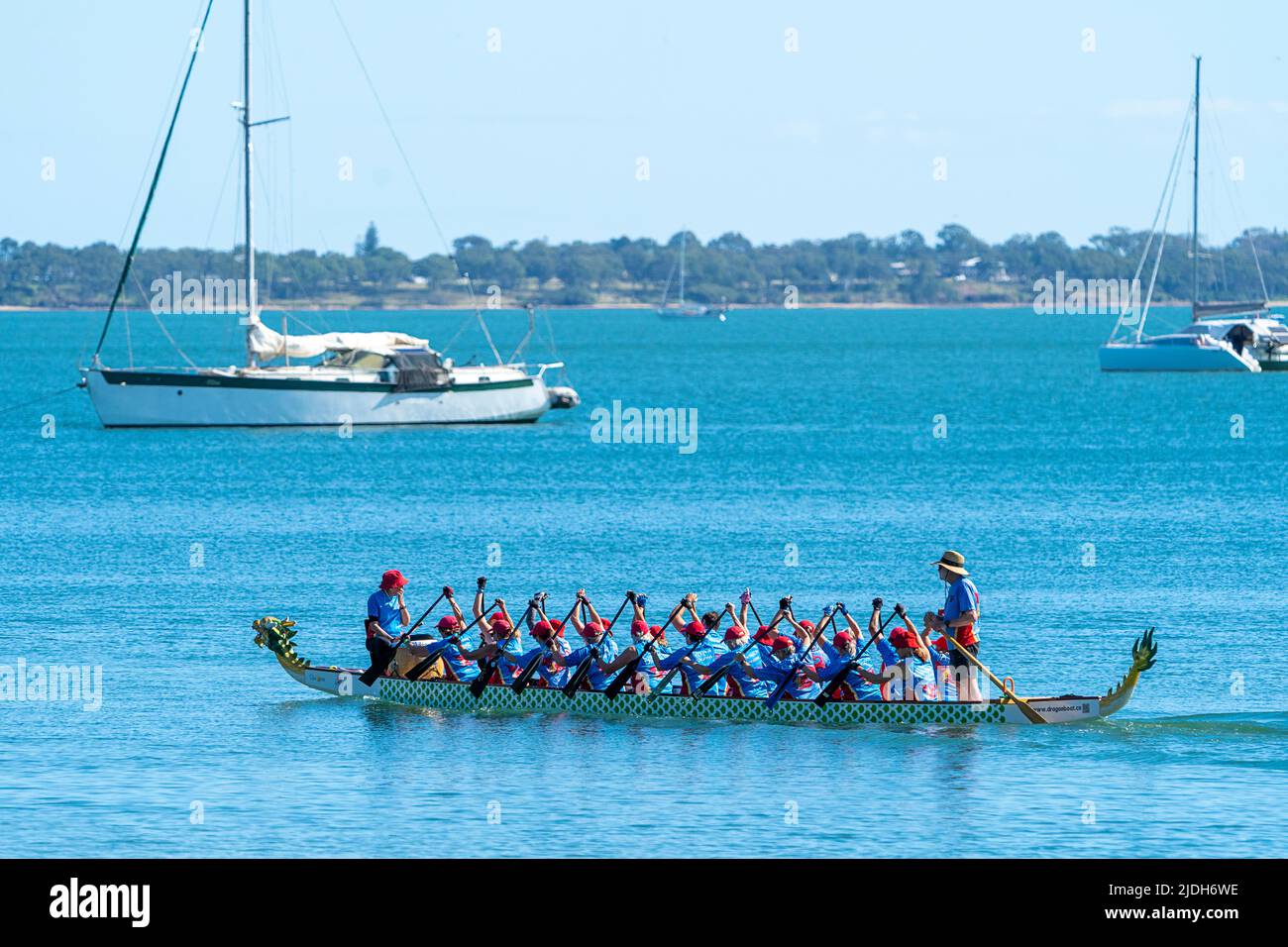 Dragon Boat paddling on calm water. Scarness Hervey Bay Queensland Australia Stock Photo