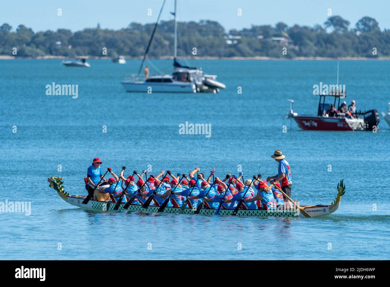 Dragon Boat paddling on calm water. Scarness Hervey Bay Queensland Australia Stock Photo