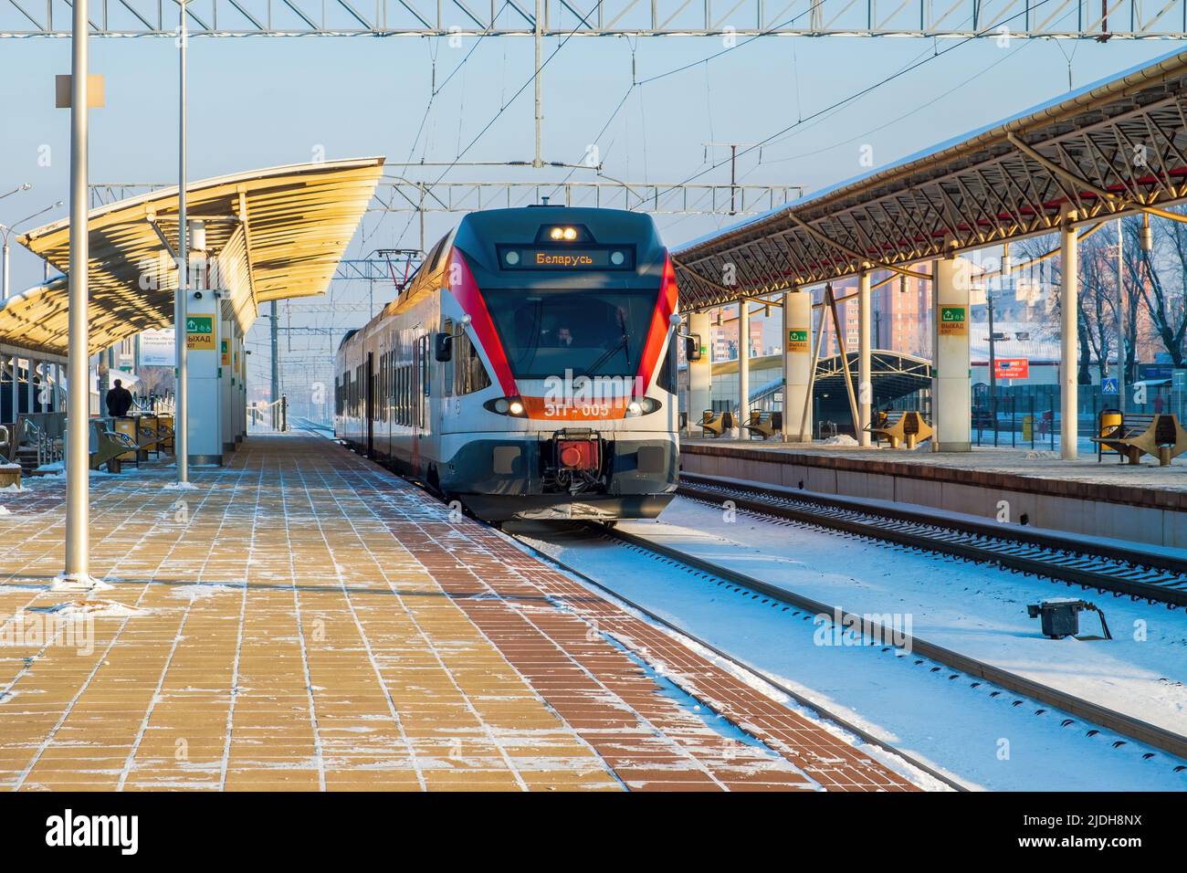 Minsk, Belarus - January 22, 2018: Electric train of city lines at the station. An empty platform. A clear winter day Stock Photo
