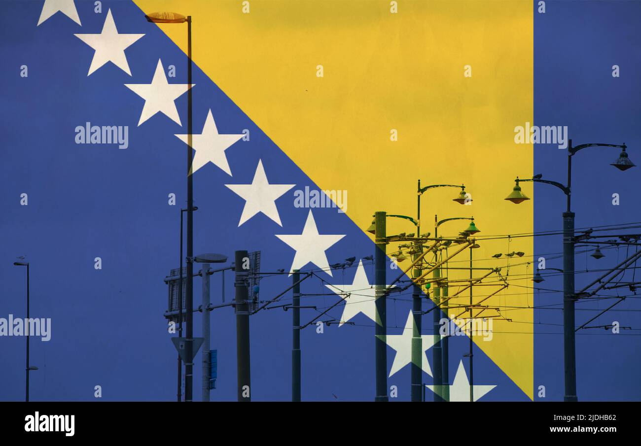 Bosnia and Herzegovina flag with tram connecting on electric line with blue sky as background, electric railway train and power supply lines, cables c Stock Photo