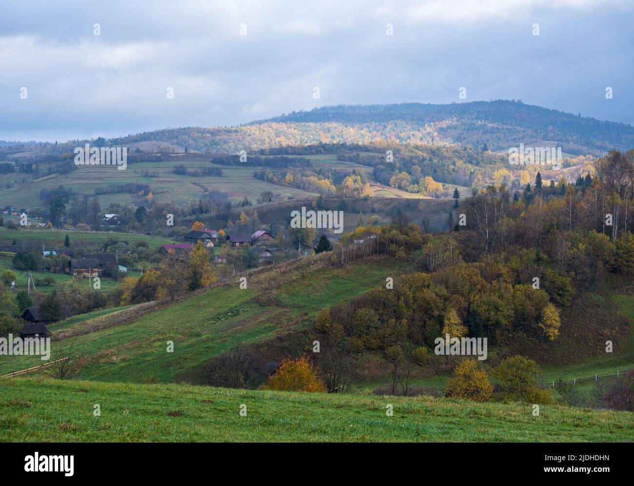 Cloudy and foggy autumn mountain countryside scene. Carpathians, Ukraine. Peaceful picturesque traveling, seasonal, nature and countryside beauty conc Stock Photo