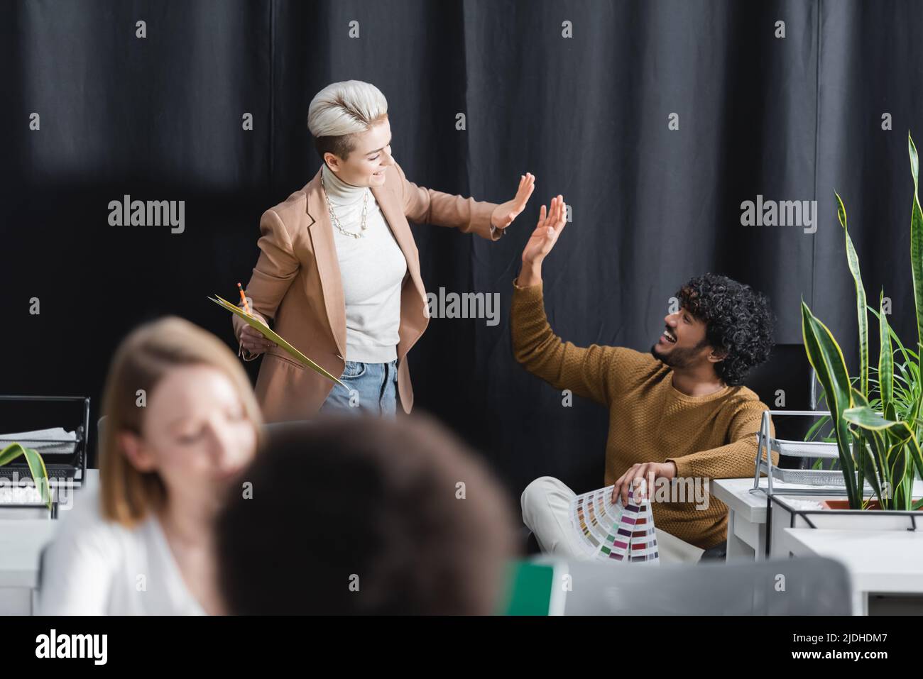 indian man giving high five to happy woman in advertising agency Stock ...
