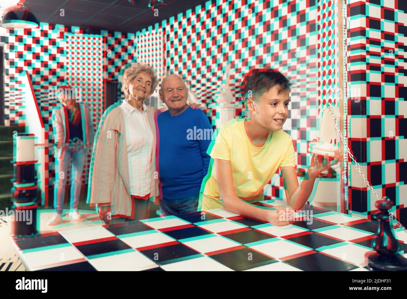 Grandparents with teenager boy discuss the game in chess quest room