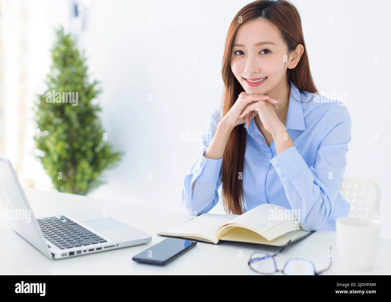 Beautiful Asian young business woman working in the office Stock Photo