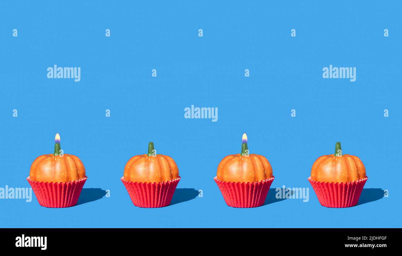 Autumn pattern with pumpkins and birthday candles. Creative holiday party background. Halloween minimal backdrop with copy space. Stock Photo