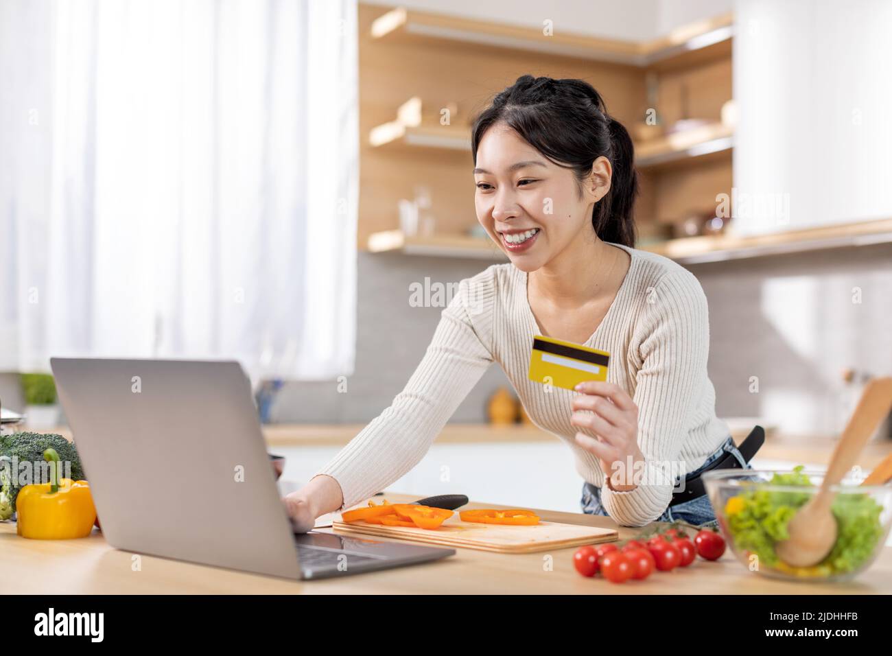 Happy chinese woman buying food online, using computer Stock Photo Alamy