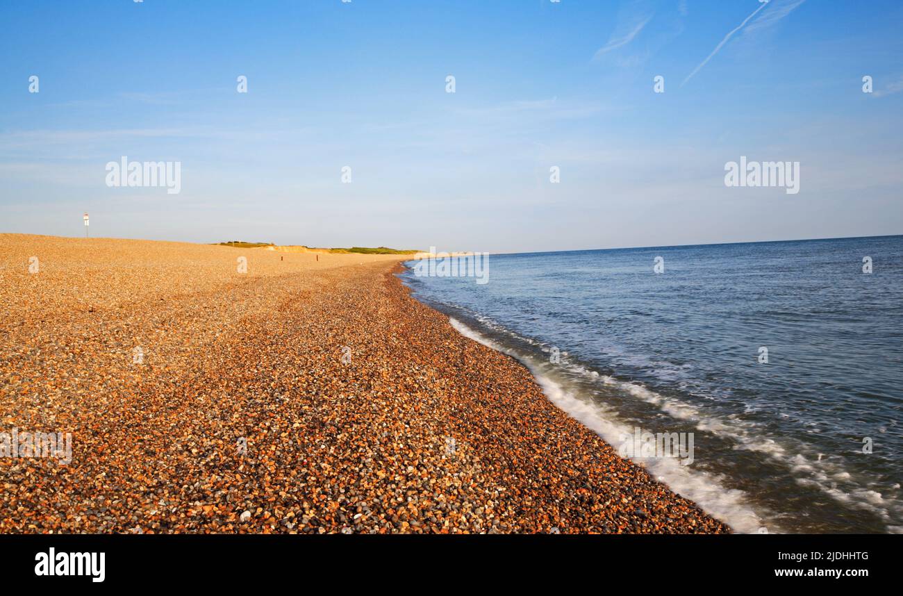 A view of the shingle beach and shoreline in summer on the North Norfolk coast at Weybourne, Norfolk, England, United Kingdom. Stock Photo