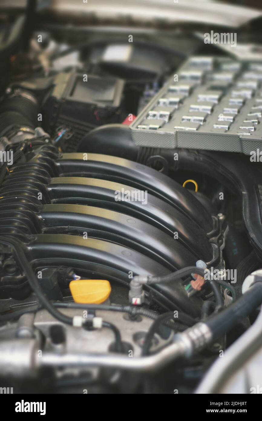 A set of socket wrenches lies on the car engine in the engine