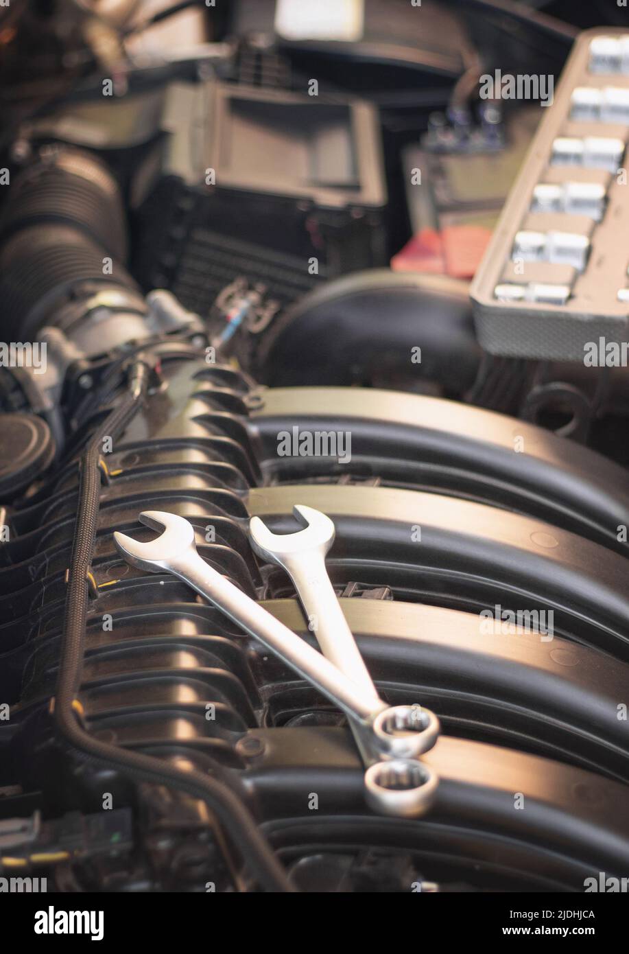 Wrenches for repairs lie on the car engine in the engine compartment