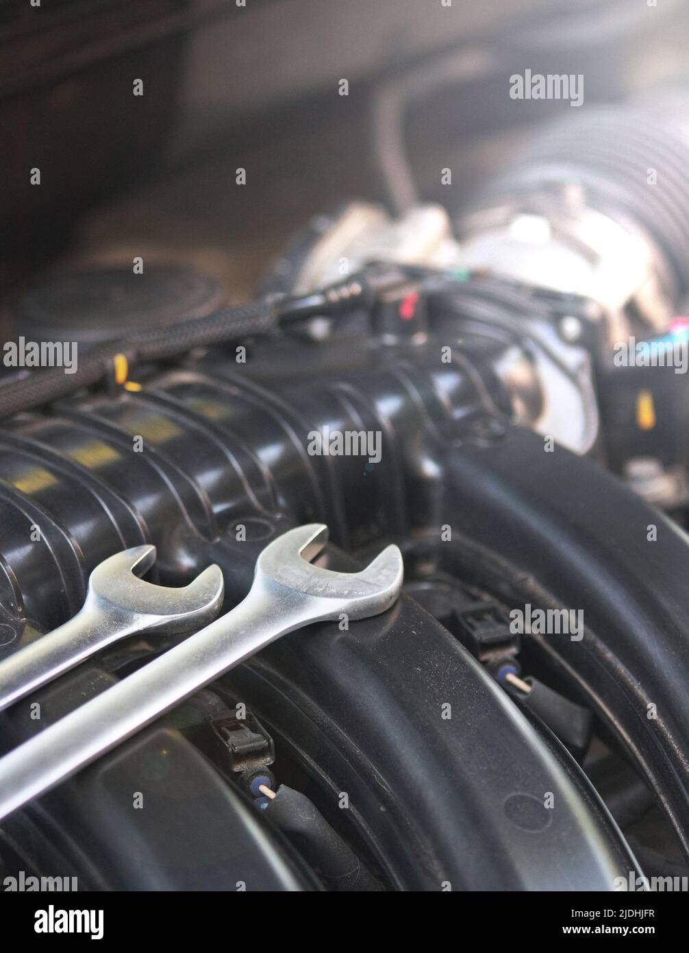 Wrenches for repairs lie on the car engine in the engine compartment