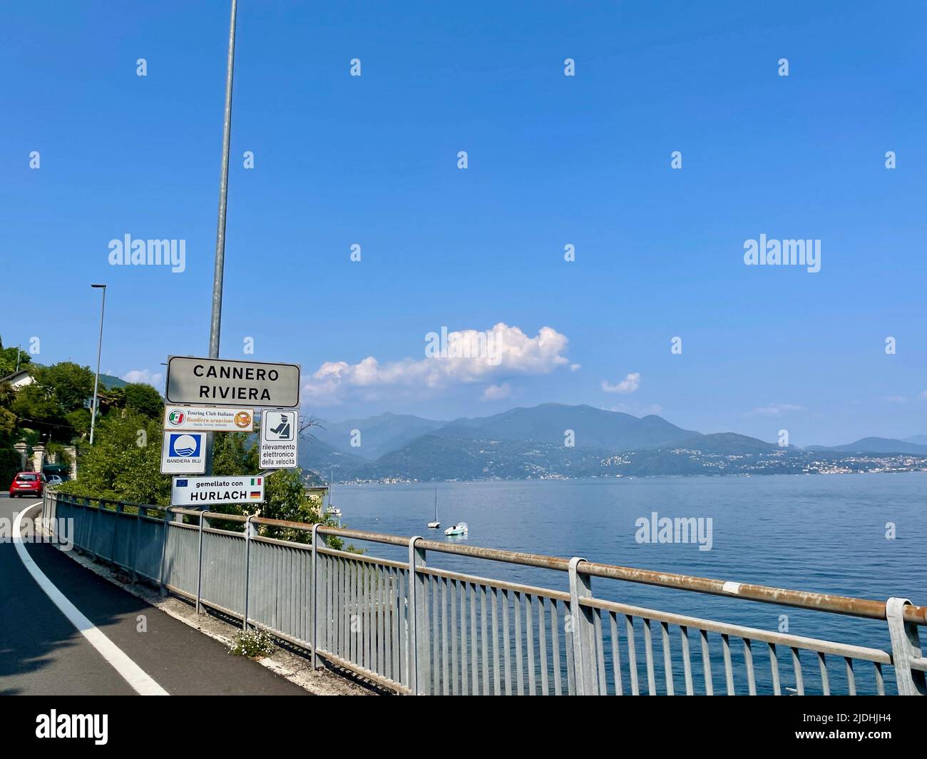 Lakeside road with street sign of Cannero Riviera. Lago Maggiore, Upper Italian lakes, Piedmont, Italy. Stock Photo